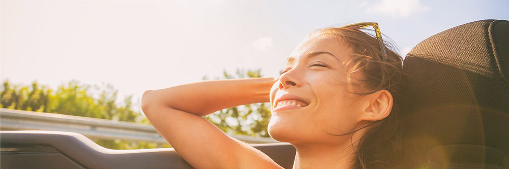 Girl smiling in her car