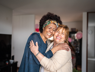 2 women hugging and smiling