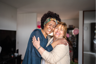 2 women hugging and smiling