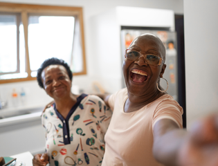 2 Women smiling and taking a photo
