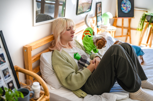 A women sitting in bed with a hot water bottle