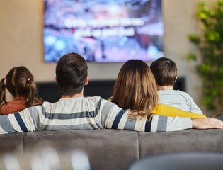 Family watching tv together