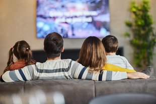 Family watching tv together