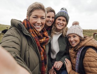 4 women taking a photo together