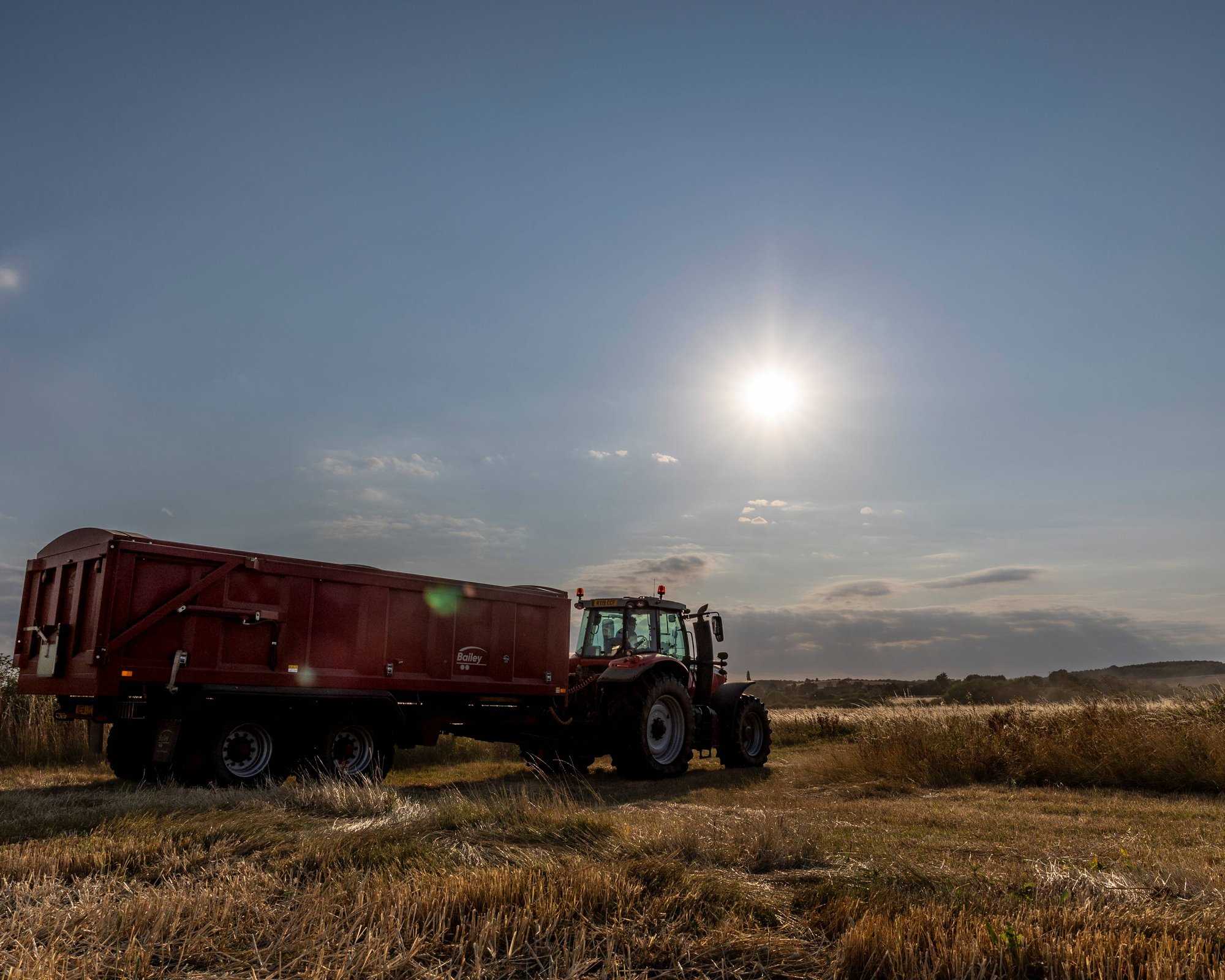 Tractor and Trailer against a sunset