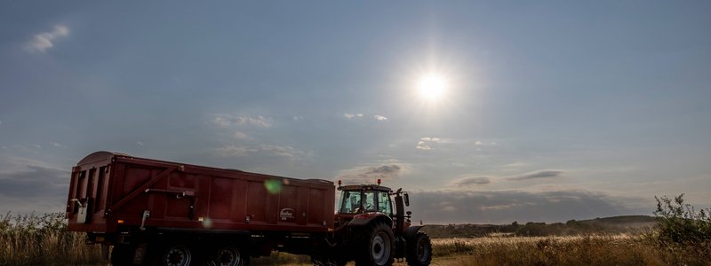 Tractor and Trailer against a sunset