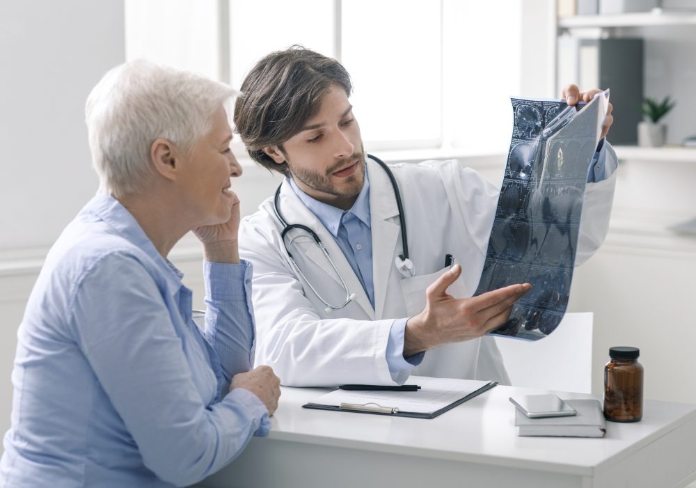 Doctor & Patient Looking at an X-Ray