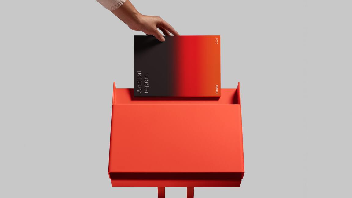 Hand placing a gradient book on a red podium, representing a bold take on branding