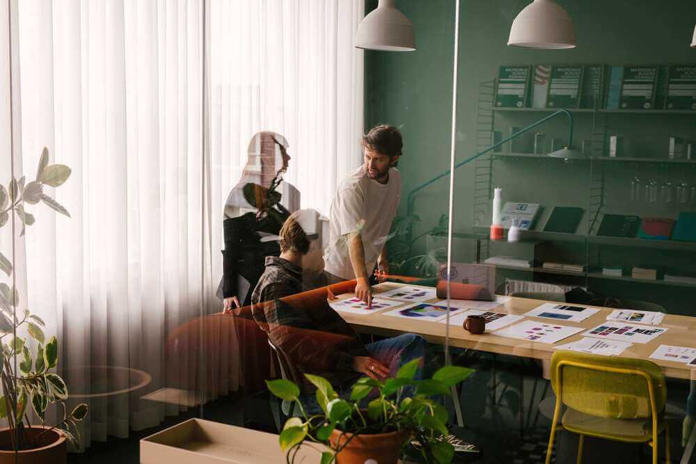 Three colleagues collaborating in Verve’s studio workspace