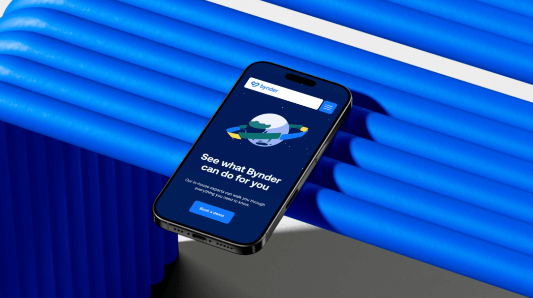 Smartphone mockup displaying the Bynder website with a “See what Bynder can do for you” message, set against a bold blue sculptural background